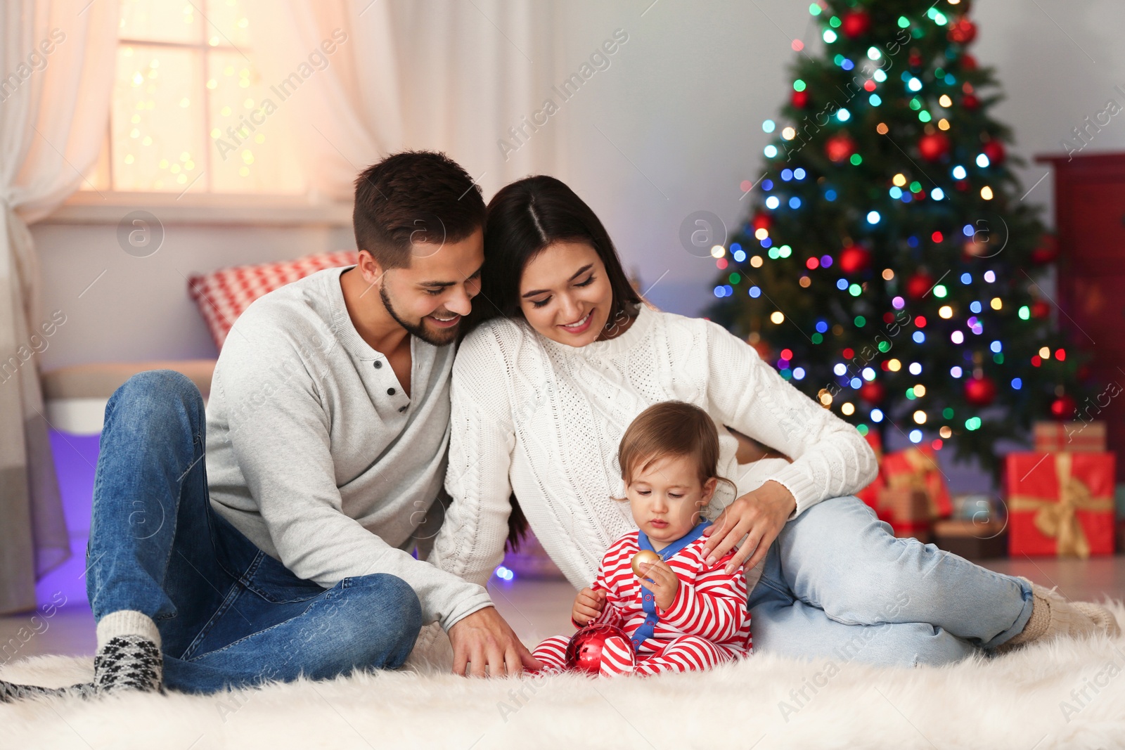 Photo of Happy family with cute baby at home. Christmas celebration