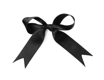 Photo of Black satin ribbon tied in bow on white background, top view