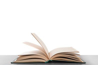 Photo of Open old hardcover book on grey table