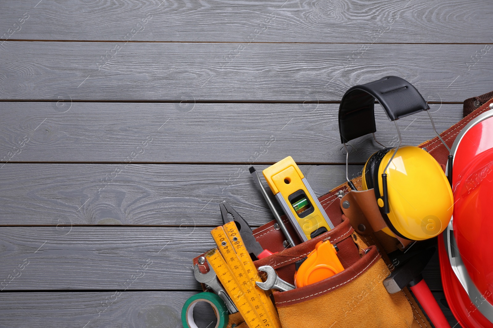 Photo of Flat lay composition with different construction tools and space for text on grey wooden background