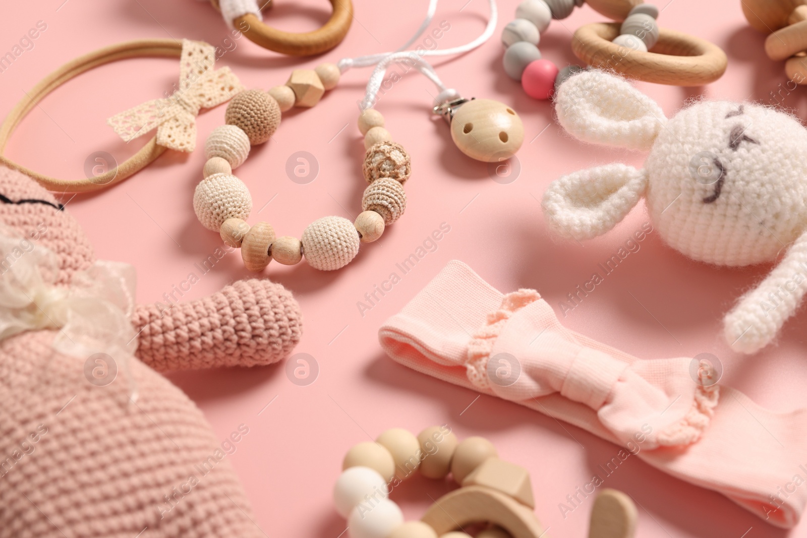 Photo of Different baby accessories on pink background, closeup