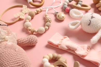 Different baby accessories on pink background, closeup