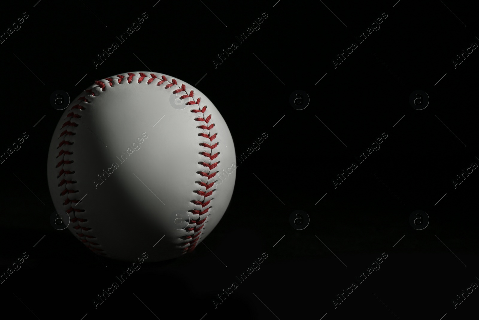 Photo of Baseball ball on black background, space for text. Sports game