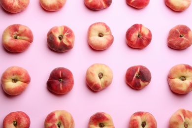 Fresh donut peaches on light pink background, flat lay