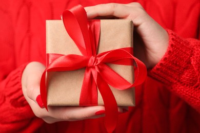 Christmas present. Woman holding gift box, closeup