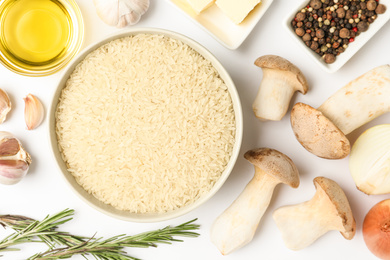 Photo of Different ingredients on white background, top view. Risotto recipe