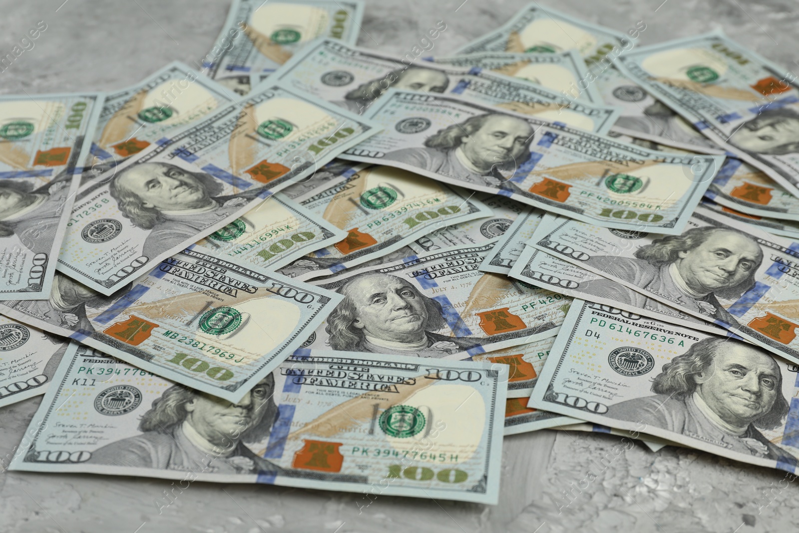 Photo of Money exchange. Dollar banknotes on grey stone background