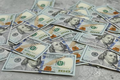 Photo of Money exchange. Dollar banknotes on grey stone background