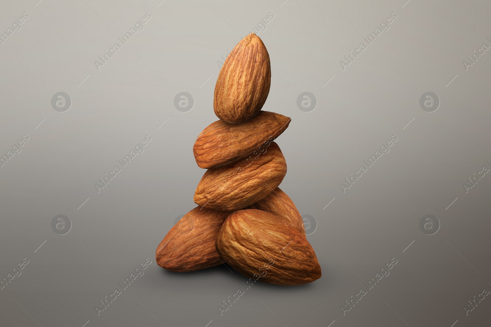 Image of Many almond nuts on grey gradient background