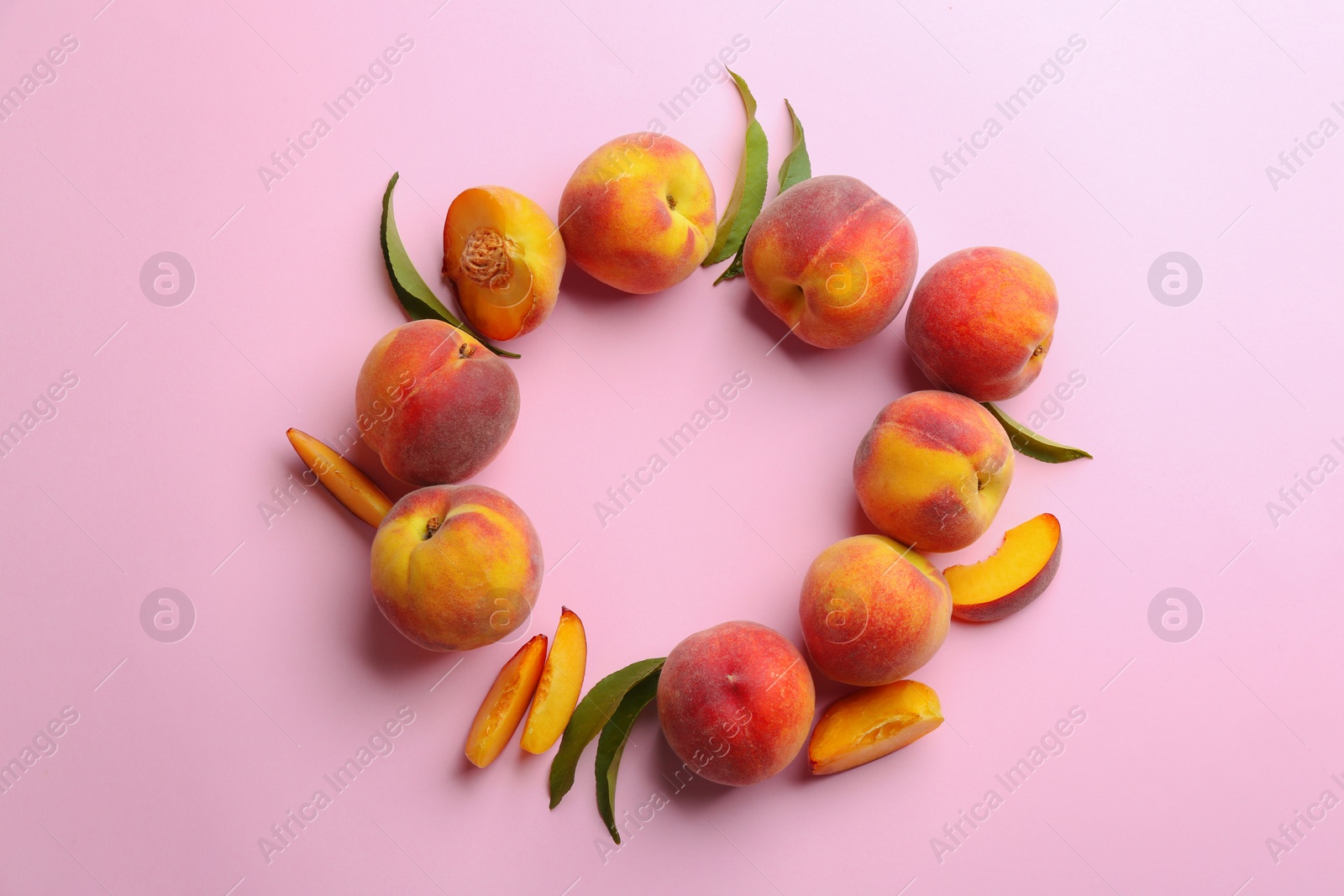 Photo of Flat lay composition with fresh peaches on pink background. Space for text