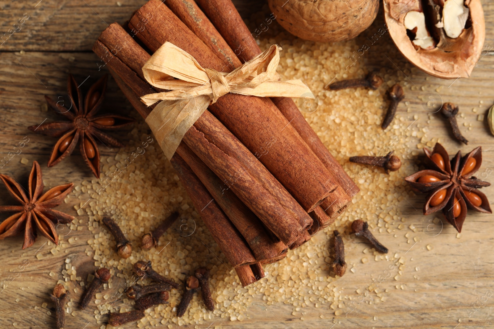 Photo of Different spices and nuts on wooden table, flat lay