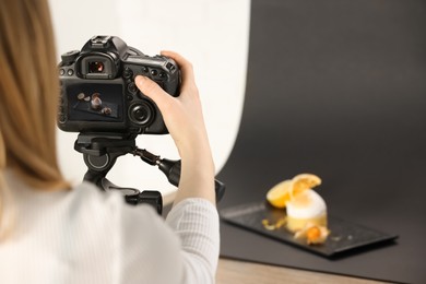 Photo of Food stylist taking photo of delicious dessert in studio, closeup. Space for text