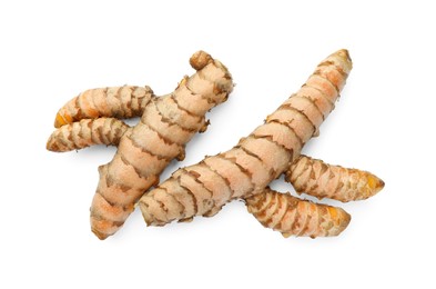 Photo of Fresh whole turmeric roots isolated on white, top view