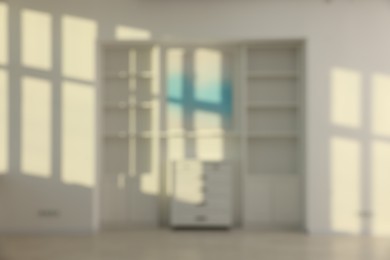 Photo of Blurred view of room with shelving unit and shadows on wall