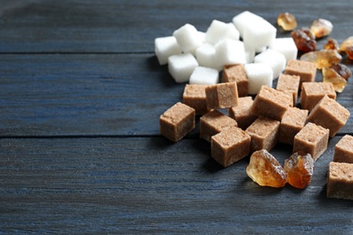 Photo of Various kinds of sugar on wooden background