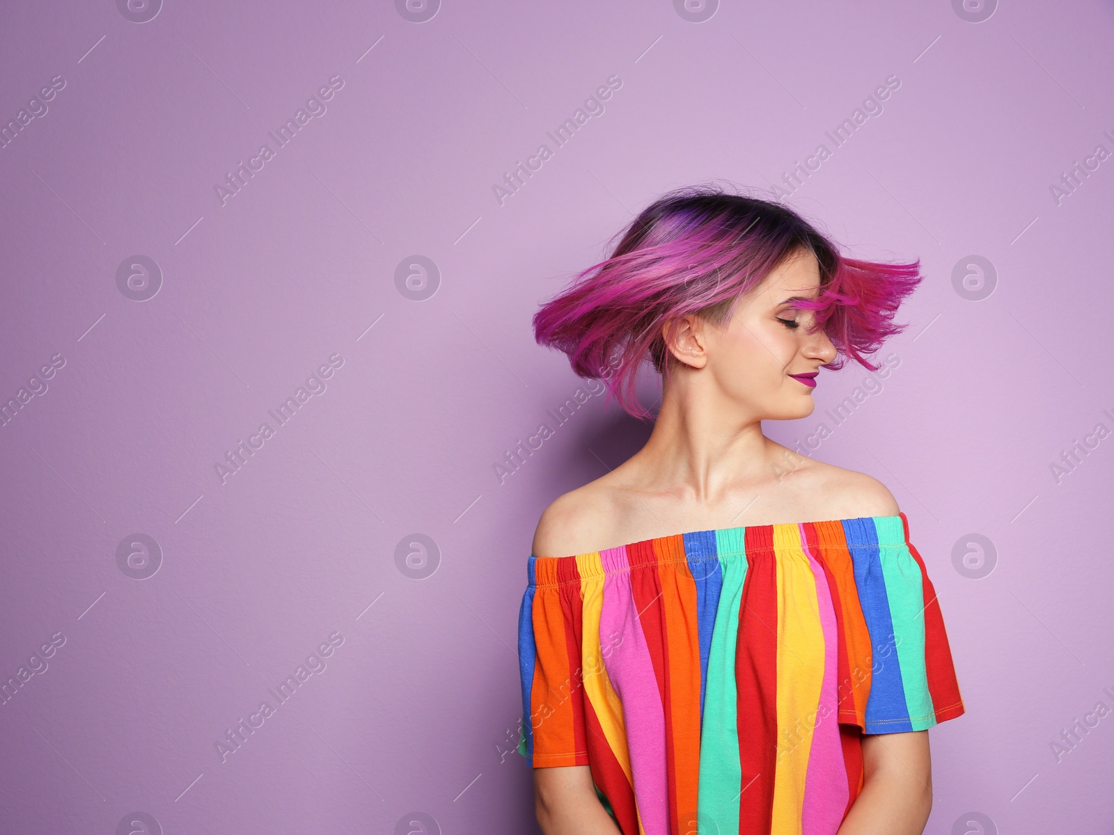 Photo of Young woman with trendy hairstyle against color background