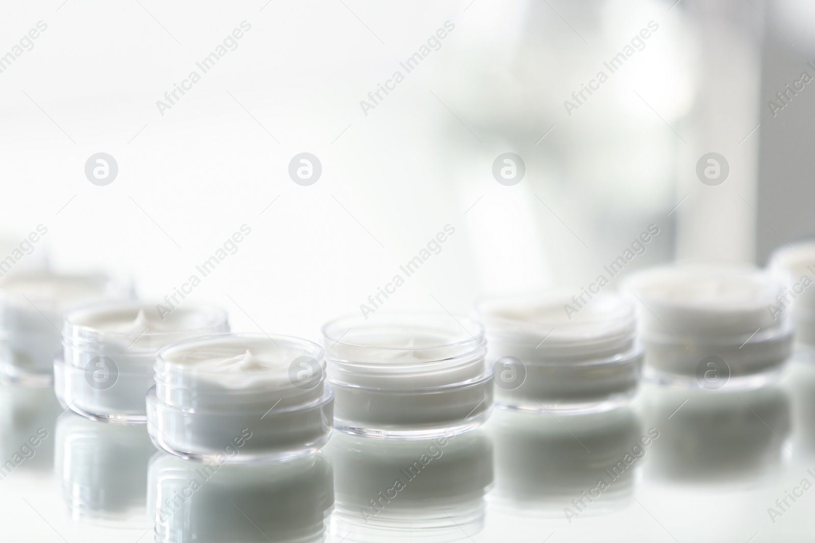 Photo of Small jars with cream in cosmetic laboratory