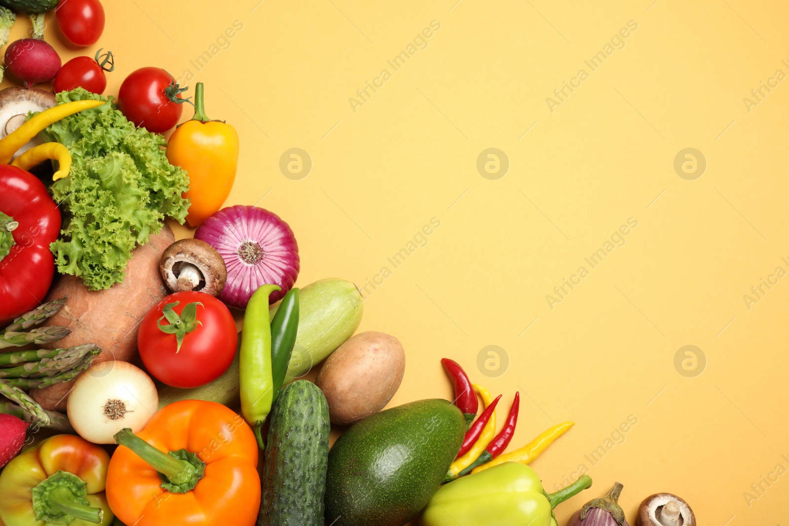 Photo of Flat lay composition with fresh vegetables on yellow background. Space for text