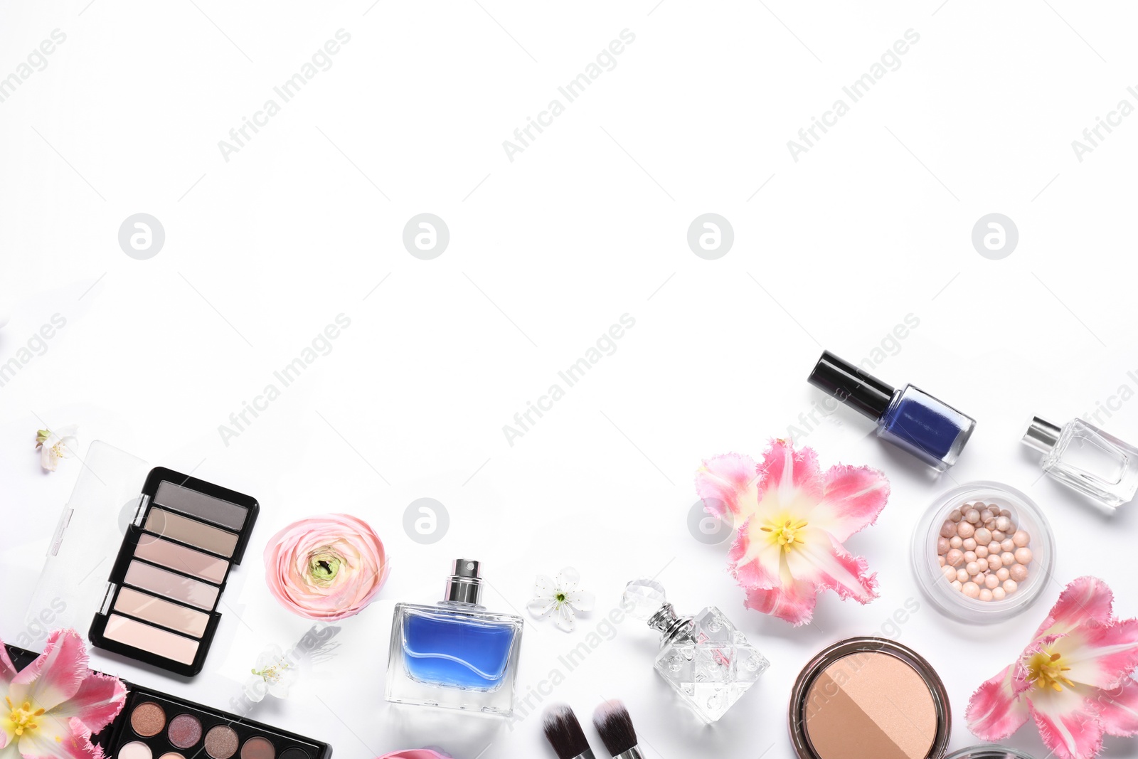 Photo of Flat lay composition with different makeup products and beautiful spring flowers on white background, space for text