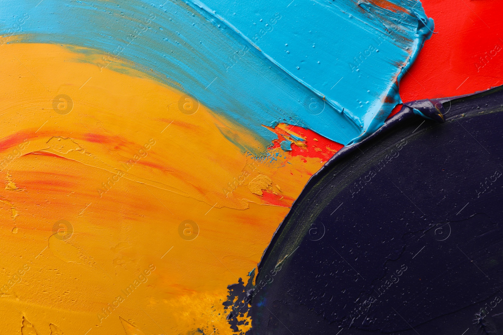 Photo of Colorful oil paint strokes as background, top view