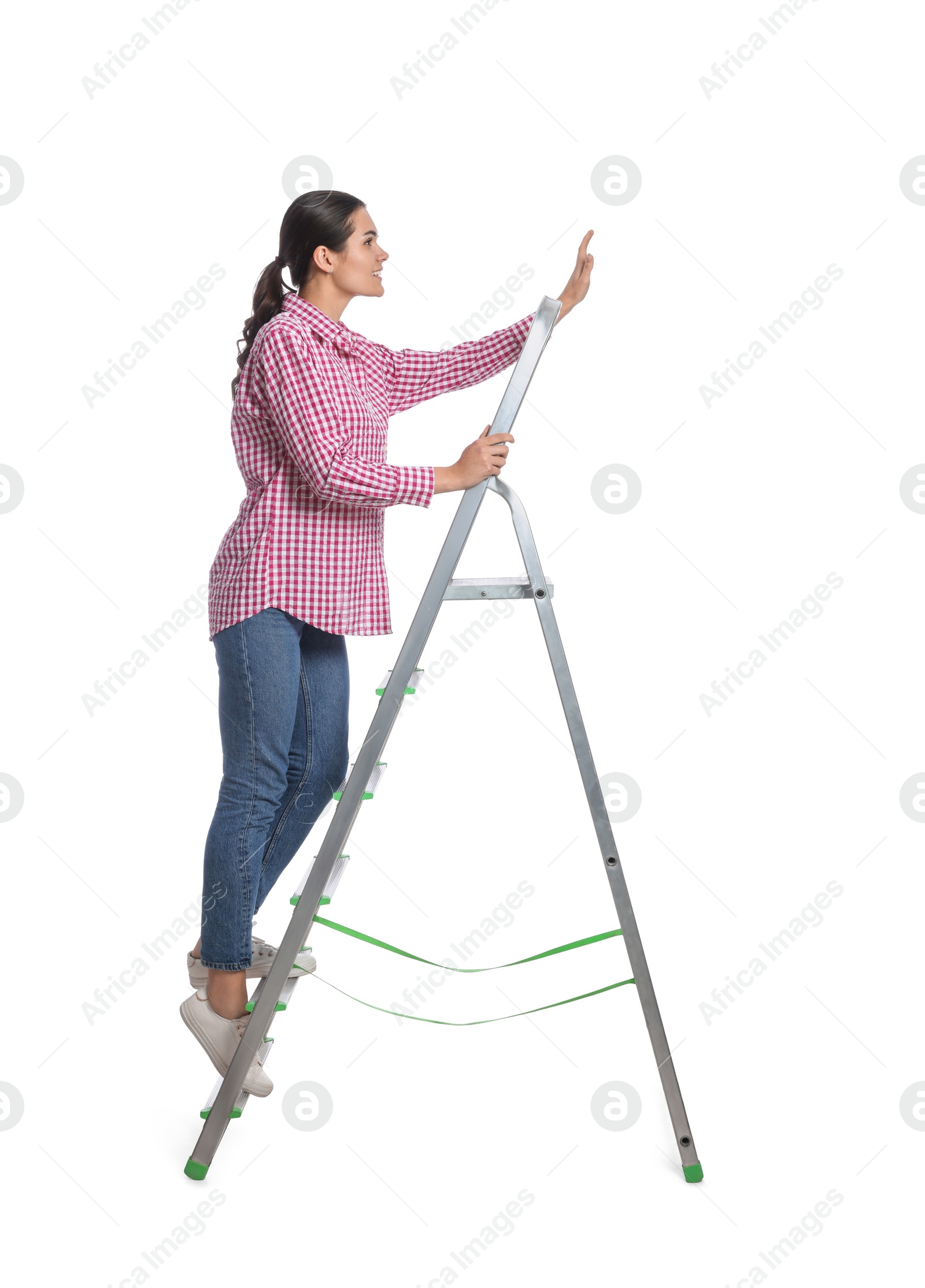 Photo of Young woman on metal ladder against white background