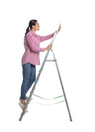Photo of Young woman on metal ladder against white background