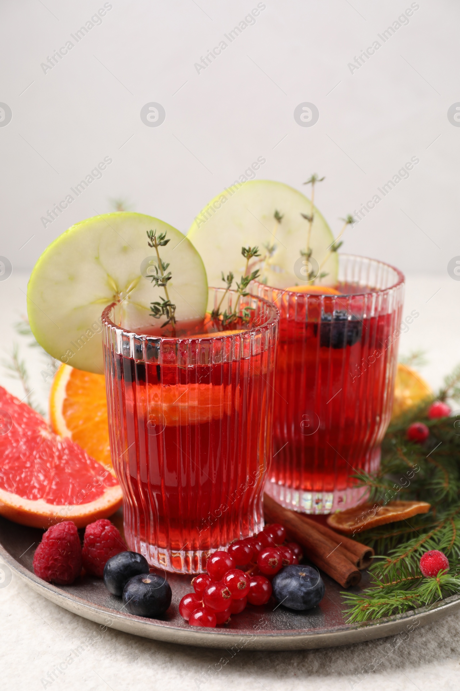 Photo of Aromatic Christmas Sangria in glasses served on table