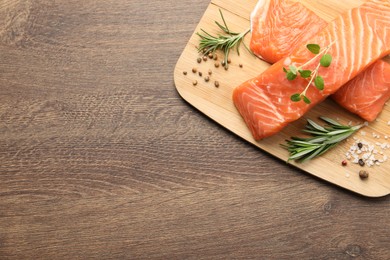 Fresh raw salmon and ingredients for marinade on wooden table, top view. Space for text