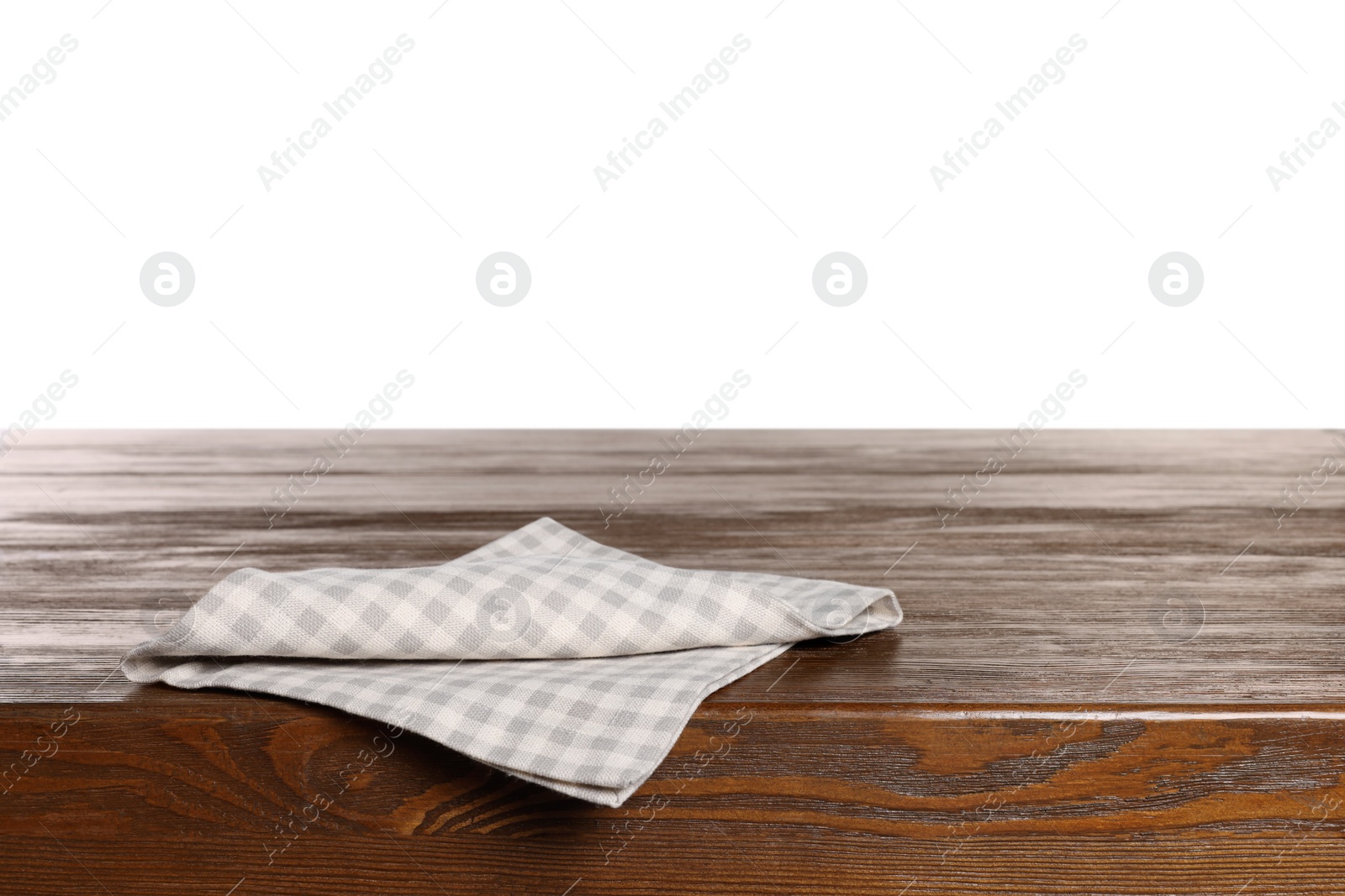 Photo of Checkered tablecloth on wooden table against white background