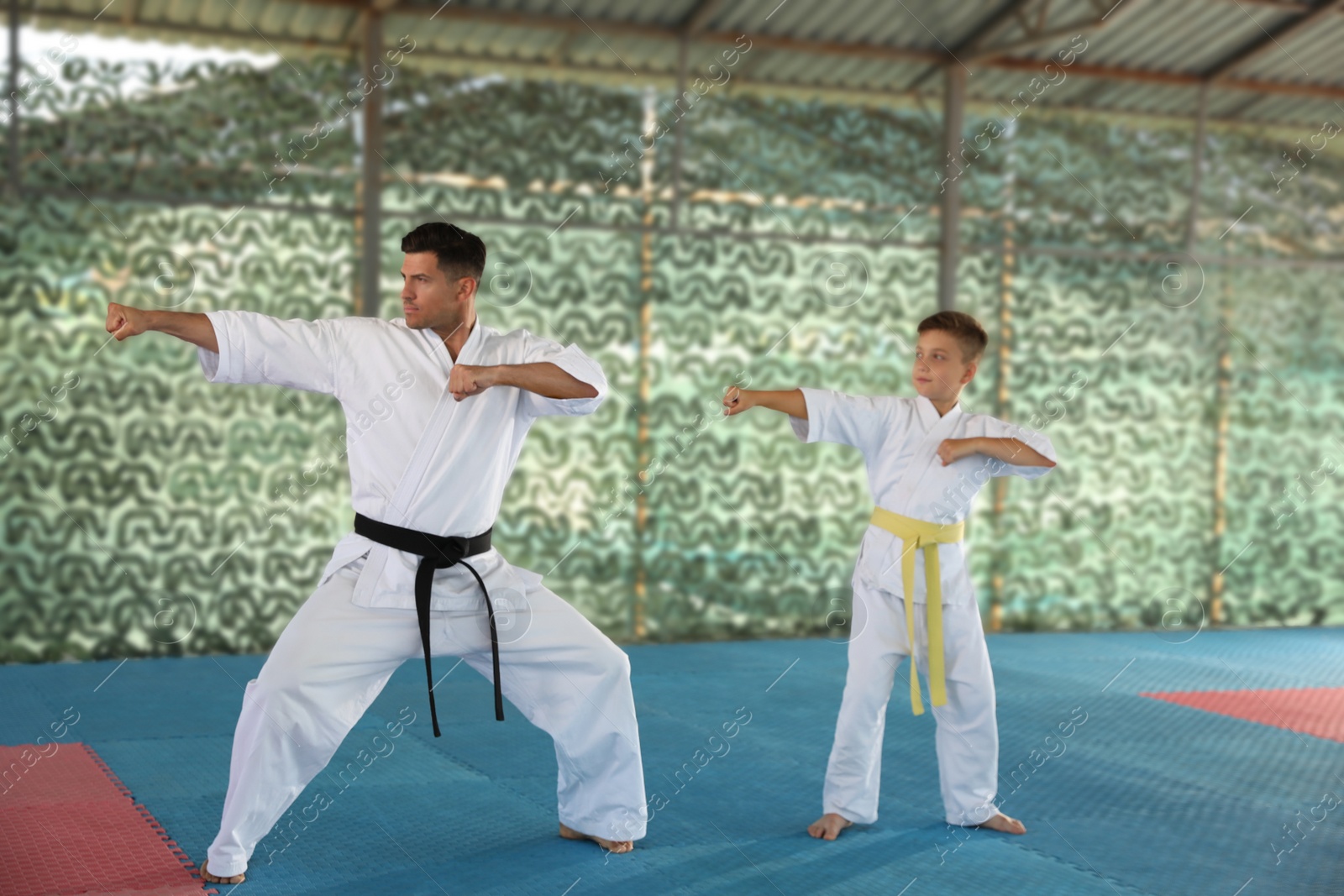 Photo of Boy and coach practicing karate at outdoor gym