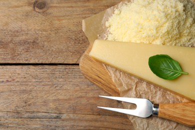 Photo of Composition with whole and grated parmesan cheese on wooden table, top view. Space for text