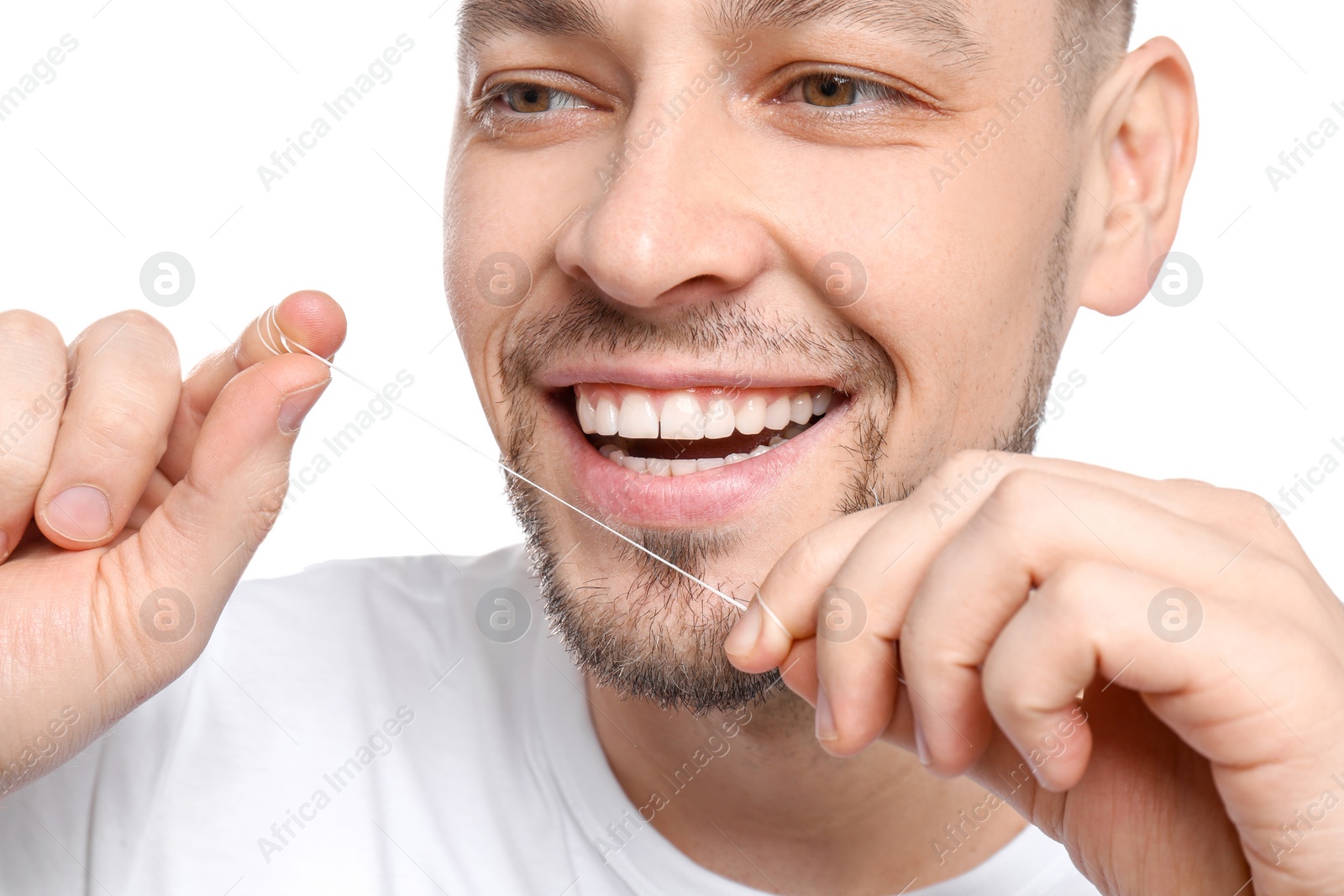 Photo of Young man flossing his teeth on white background