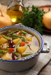 Photo of Bowl of tasty turnip soup with napkin on table