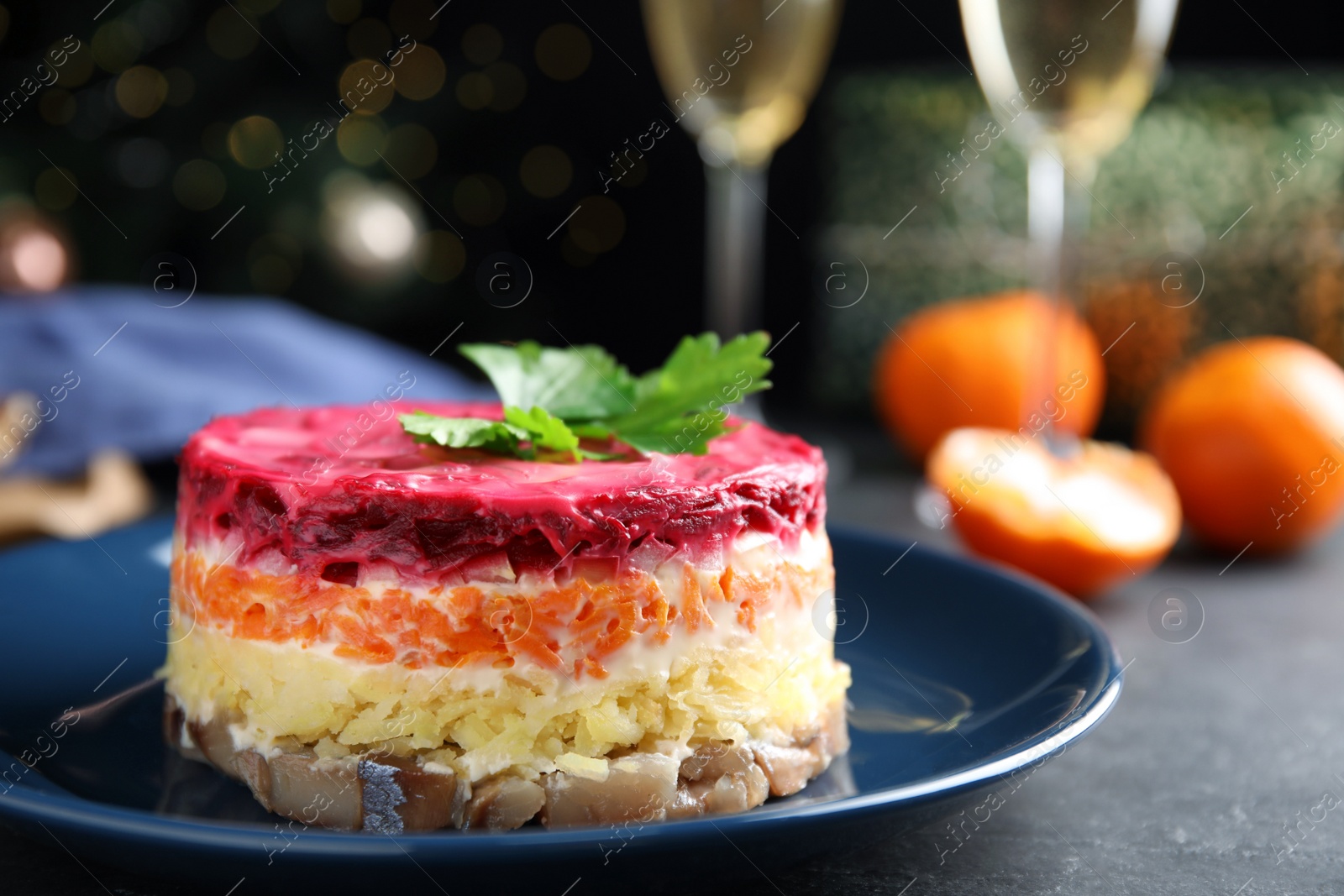 Photo of Herring under fur coat on plate, closeup. Traditional russian salad