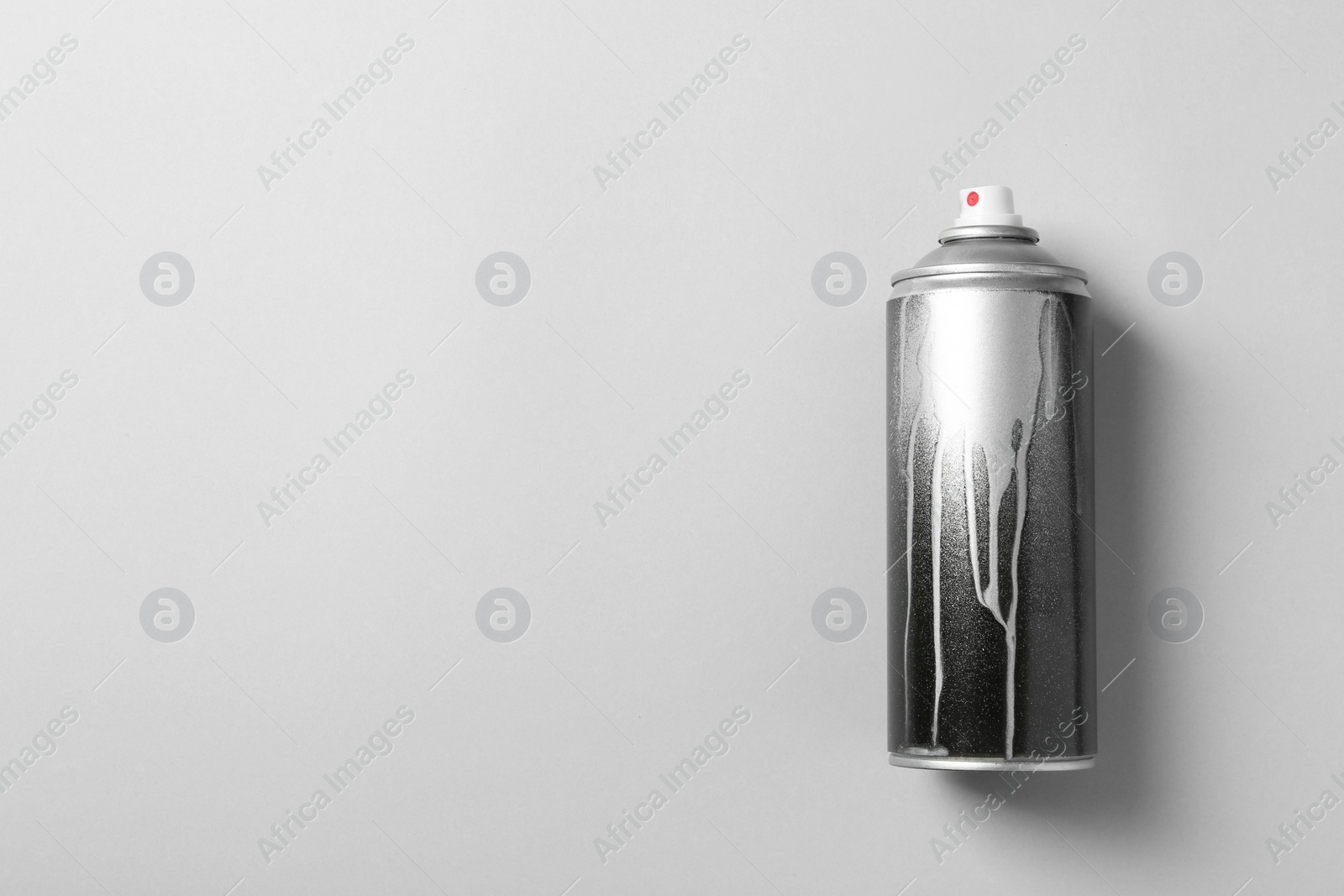 Photo of Used can of spray paint on color background, top view. Space for text