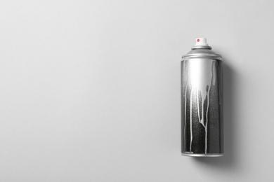 Photo of Used can of spray paint on color background, top view. Space for text