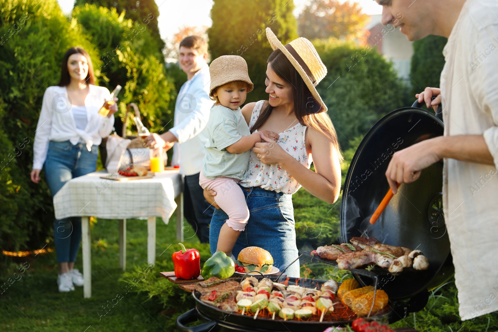 Photo of Family with friends having barbecue party outdoors