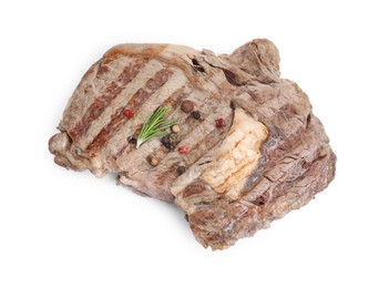 Photo of Piece of delicious grilled beef meat, rosemary and peppercorns isolated on white, above view