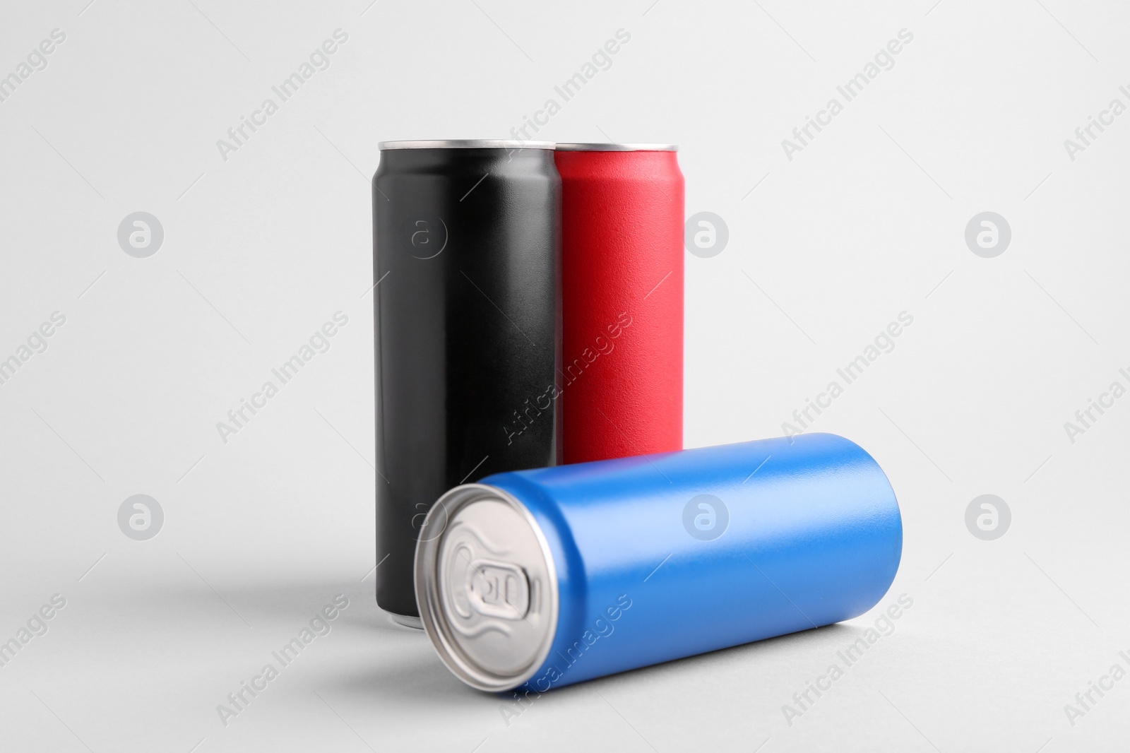 Photo of Energy drinks in colorful cans on white background