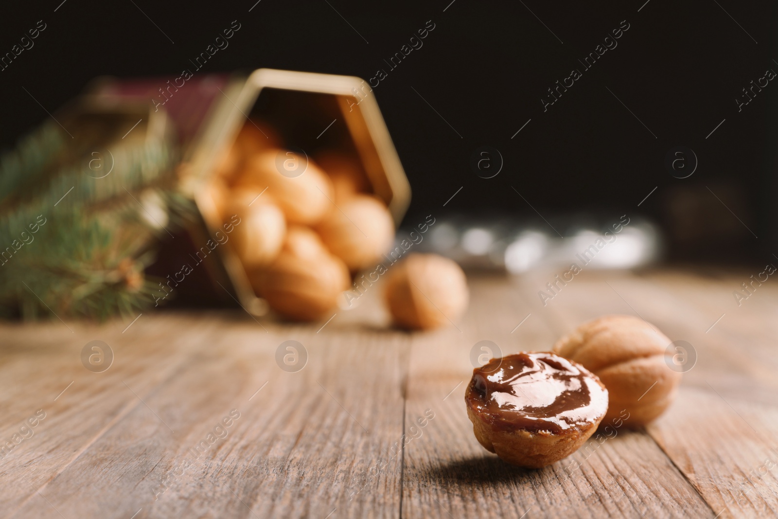 Photo of Homemade walnut shaped cookies with boiled condensed milk on wooden table. Space for text