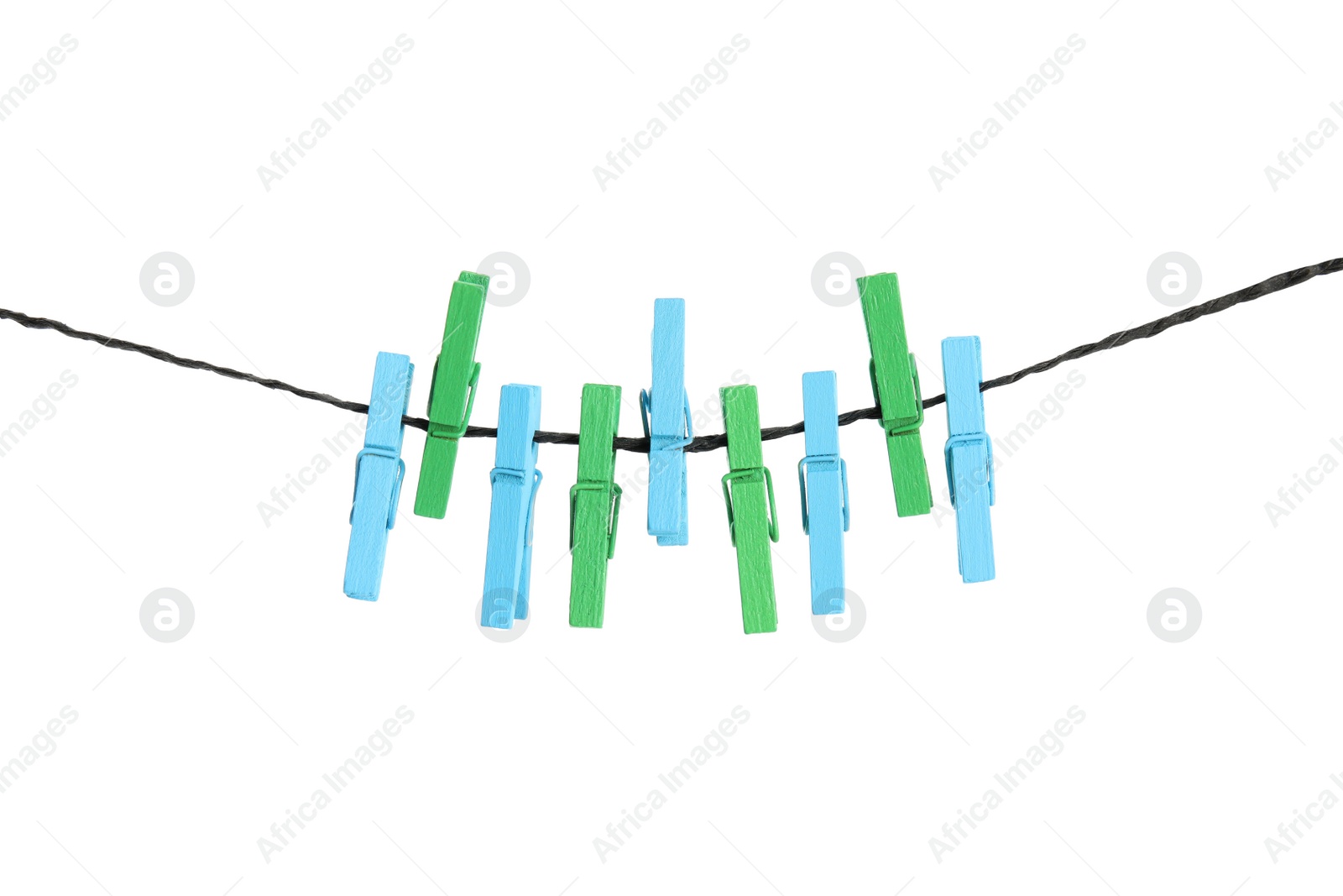 Photo of Many colorful wooden clothespins on rope against white background