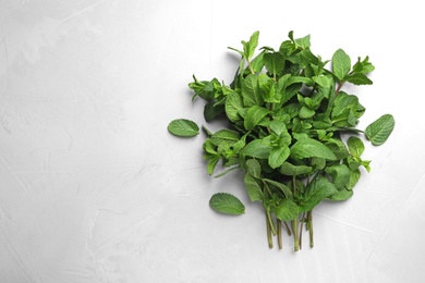 Photo of Bunch of fresh green mint and space for text on grey background, top view