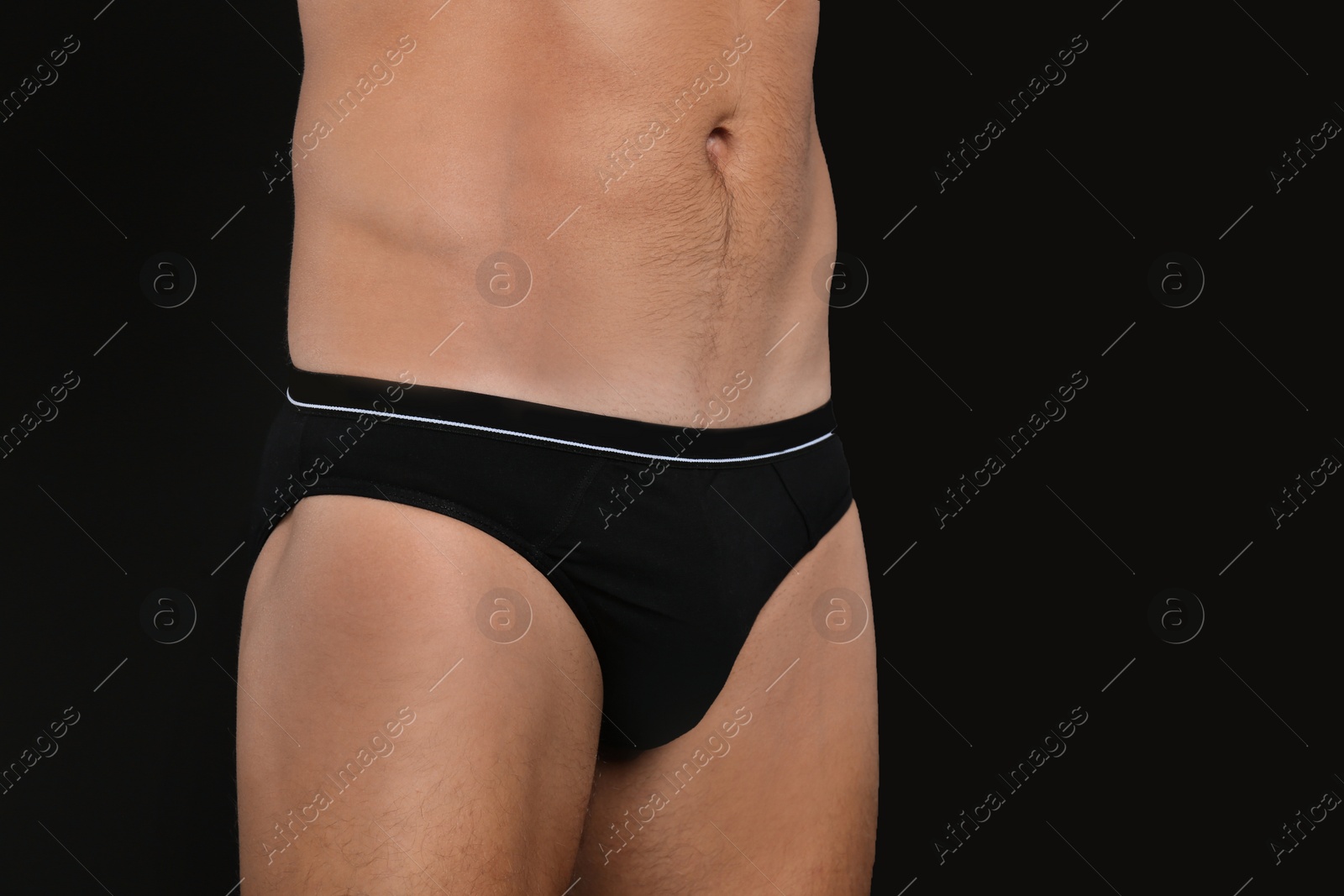 Photo of Man in underwear on black background, closeup