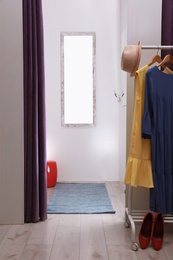 Photo of Empty dressing room in fashion store. Stylish interior