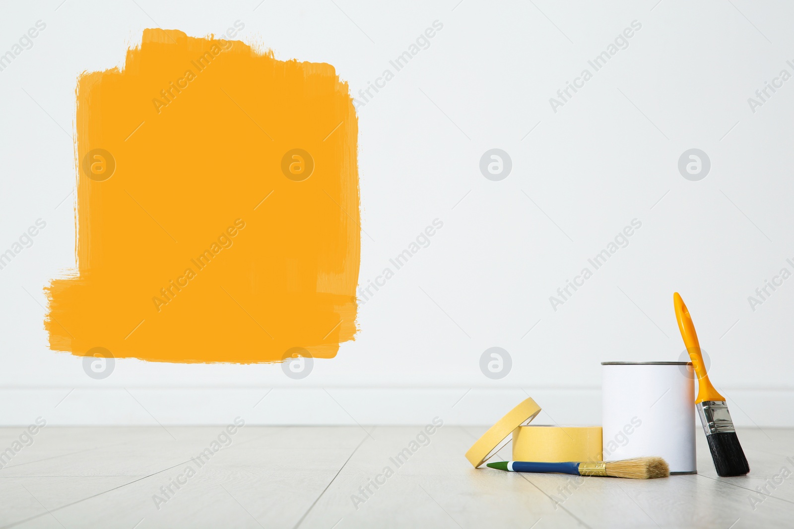 Image of Set with decorator's tools and paint on floor near white wall