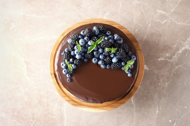 Fresh delicious homemade chocolate cake with berries on table, top view