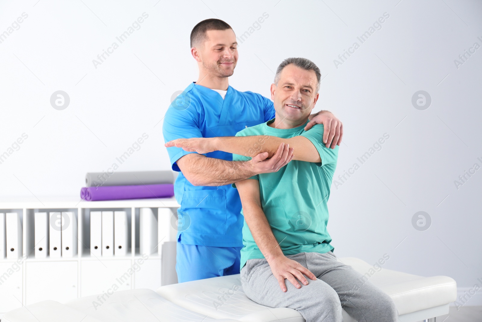 Photo of Doctor working with patient in hospital. Rehabilitation physiotherapy