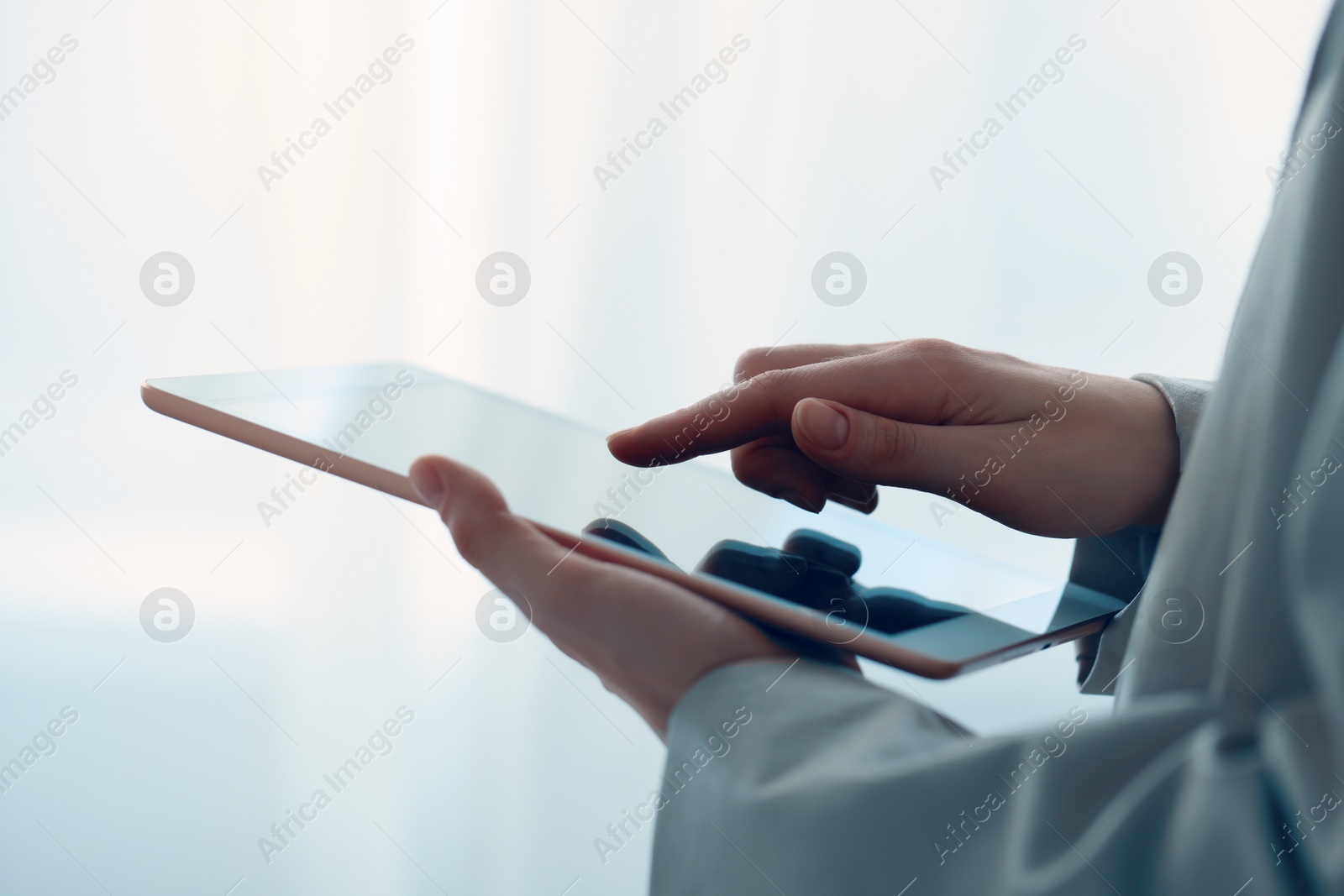 Photo of Closeup view of woman using modern tablet on blurred background