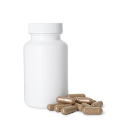 Photo of Bottle and pile of vitamin pills isolated on white