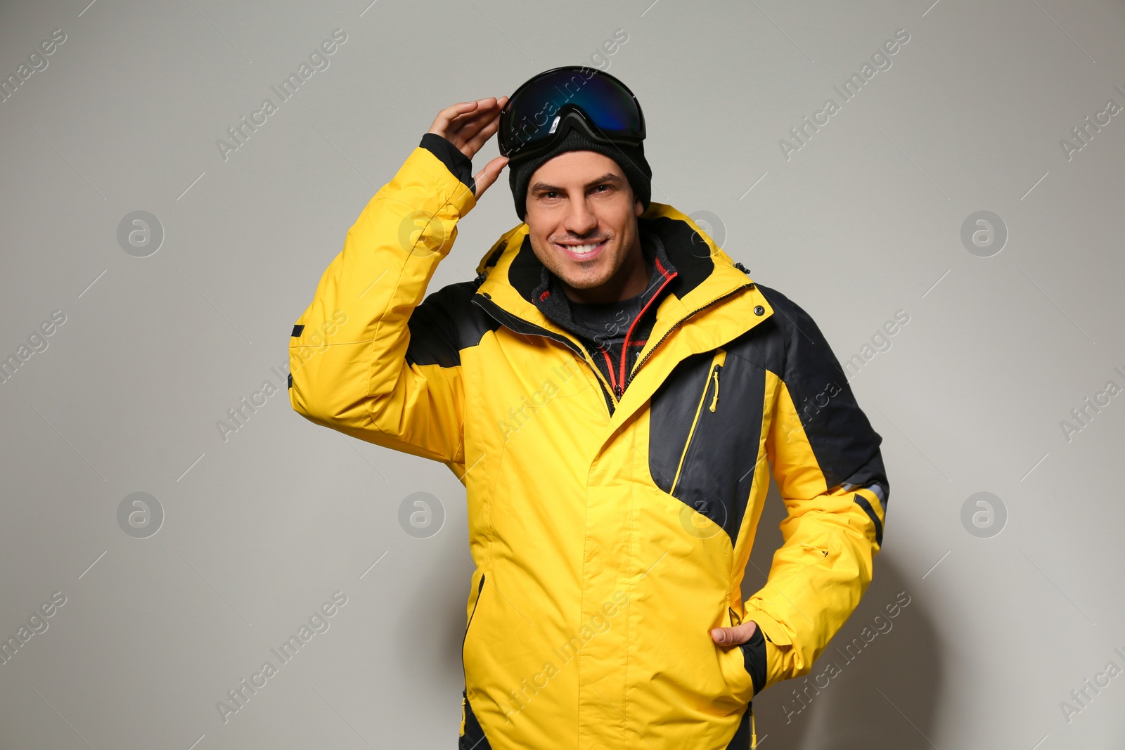 Photo of Man wearing stylish winter sport clothes on light grey background